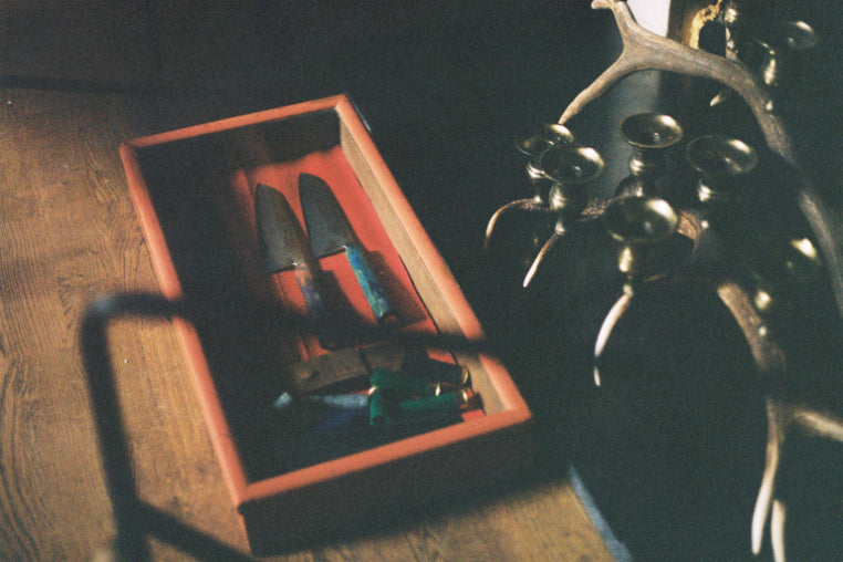 ALT=Clement Knives chefs knife and bullet casings in a display cabinet at Boath House for the Bard Scotland retail residency.