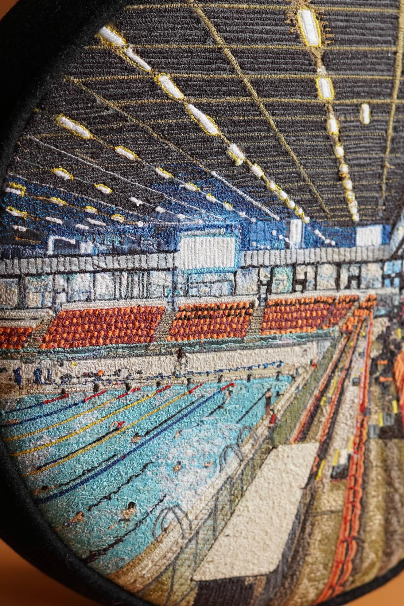 ALT= Close up of the embroidery on the Embroidered Commonwealth Stool by Laura Lees. Machine embroidered in bright thread.