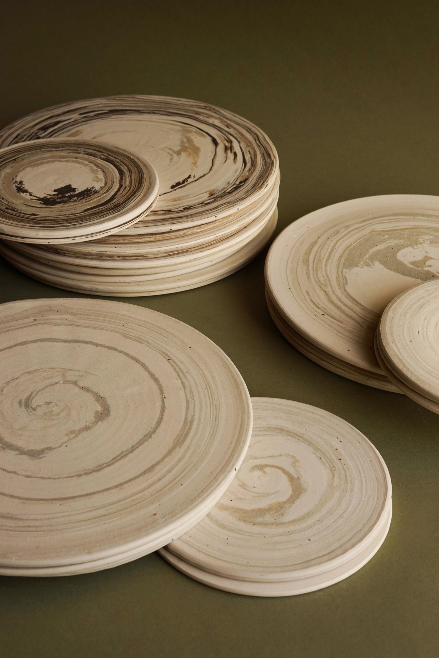 From top to bottom: Shetland platters, Orkney platters, and Harris platters. ALT=Hand thrown ceramic platters using Scottish sand.