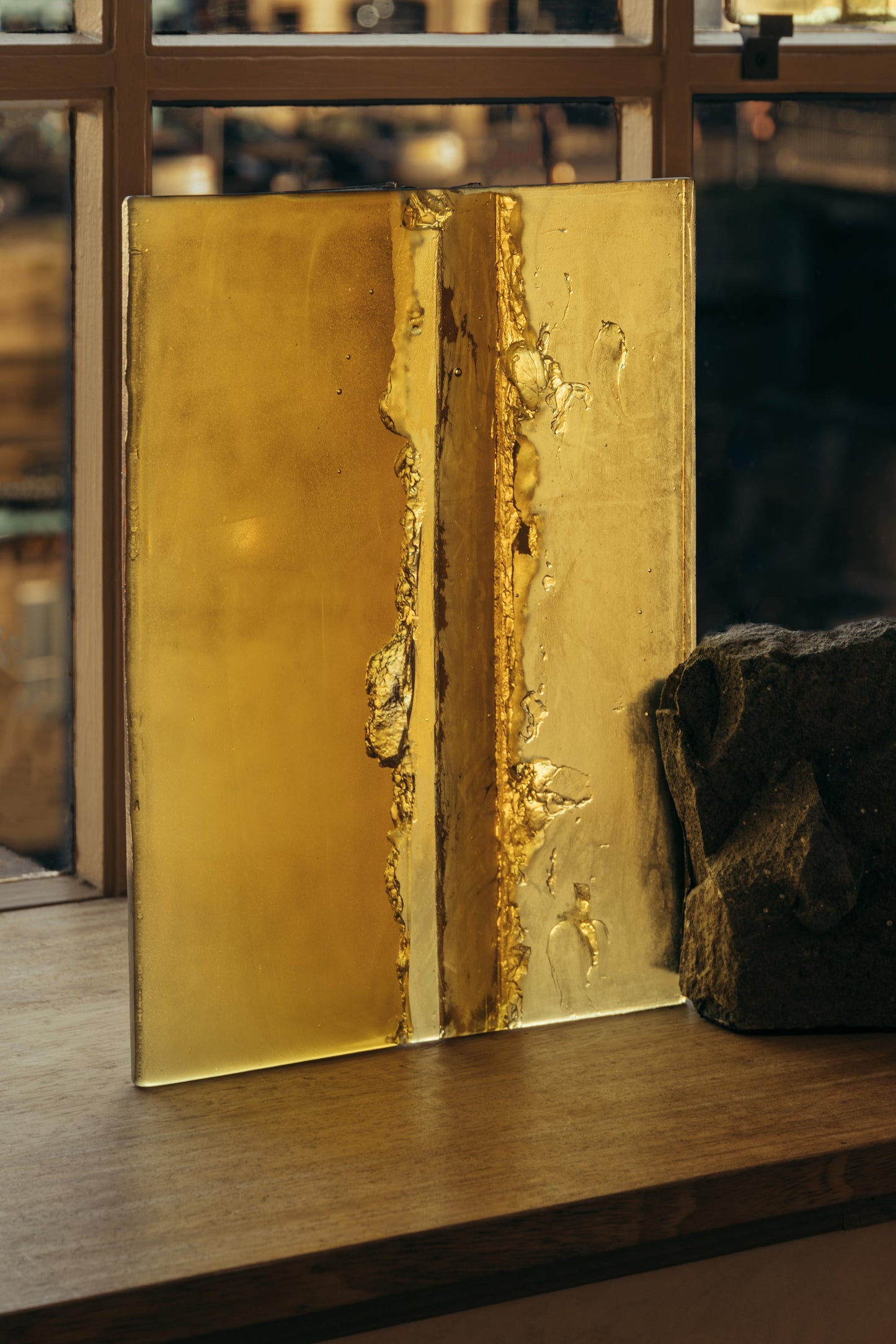 ALT= Amber, part of Haptic Light by Jack Brindley of Pavillion Pavillion. A glassware and stone piece that reflects and refracts light, a sort of prism.