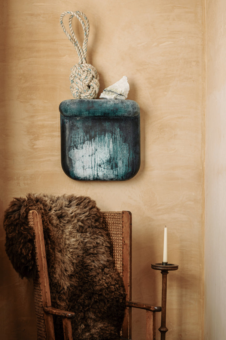 ALT= Verdigris Corbel, a textured blue ceramic sculpture by James Rigler. Used here as a shelf for other objects available at Bard Scotland.