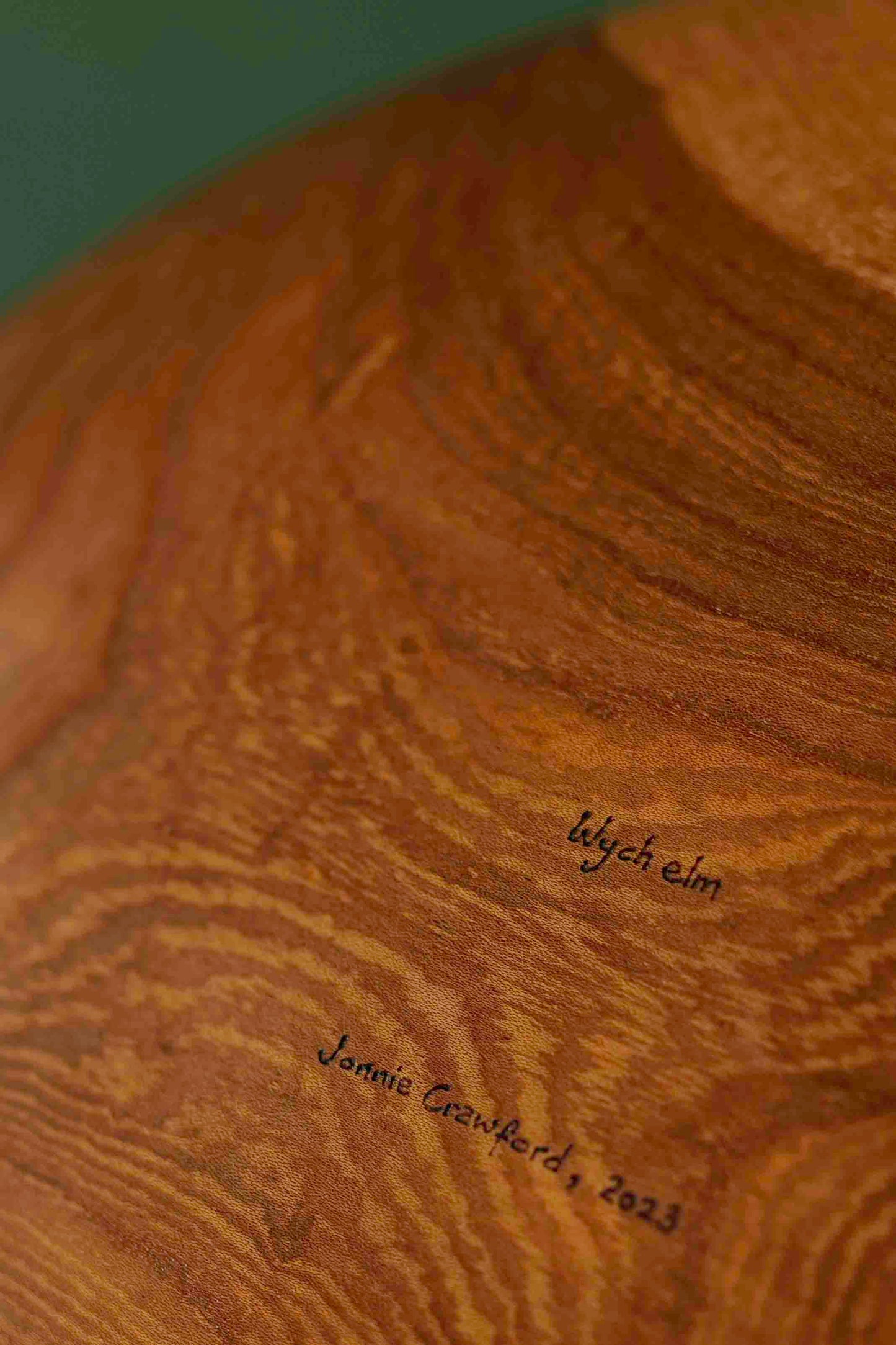 ALT=Jonnie Crawford's makers mark on the underneath of the Wych Elm bowl. It reads 'Wych elm' and 'Jonnie Crawford, 2023'.