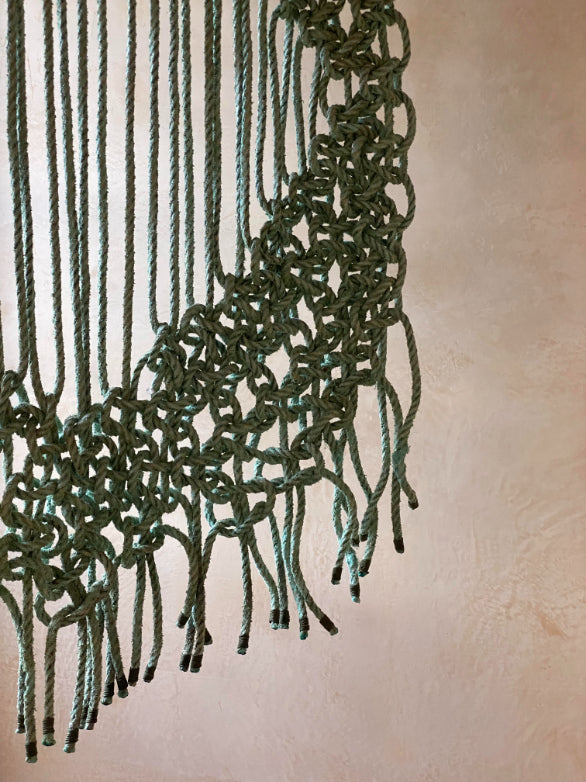 ALT=Close up shot of the knotted structure of a sea rope hanging by A Frayed Knot. An Orkney based company who creates homeware and utilities from sea rope.