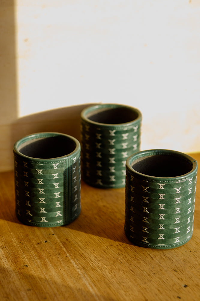 ALT=Green leather pencil pots or Poit in Gaelic. Hand made by Iseabal Hendry using woven and lace techniques.
