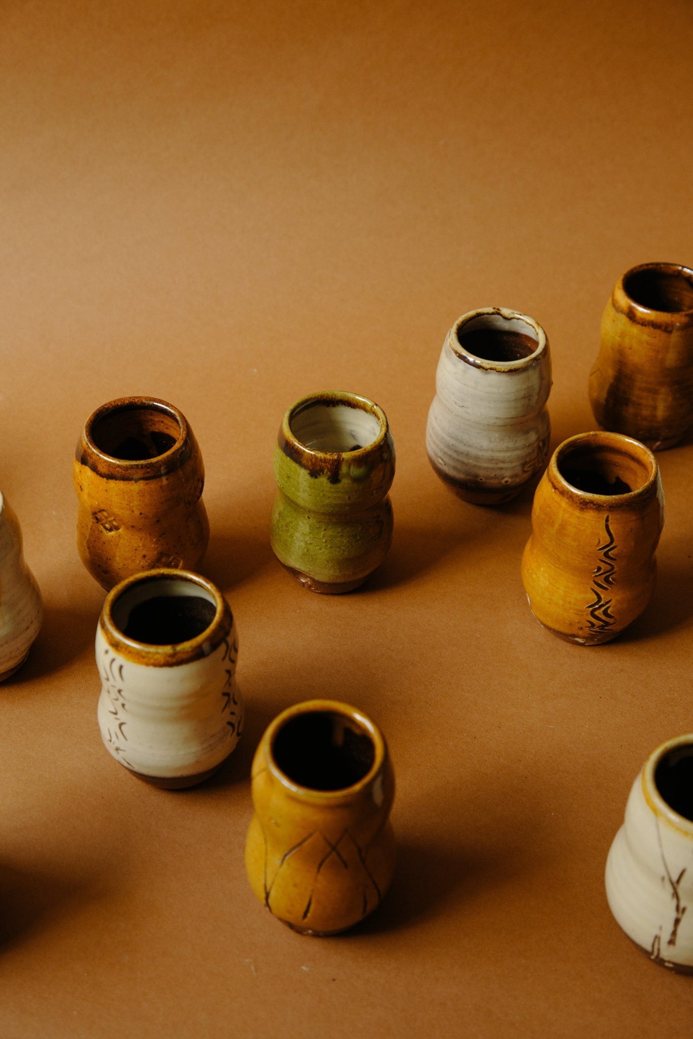 ALT=A group of small whisky vessels with a variety of colour, stamps and markings. Each unique.