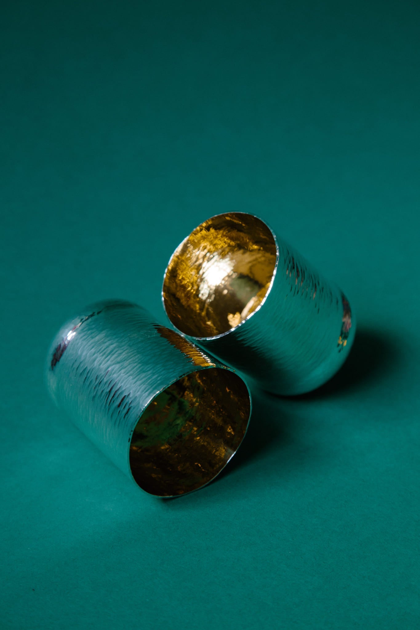 ALT=Two hand raised sterling silver cups with gold plated inner surfaces resting upon one another.