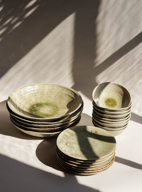 ALT=Stacks of Ingot object ash glazed platters, bowls and plates. Shot in the sunshine at Bard Scotland, Leith.