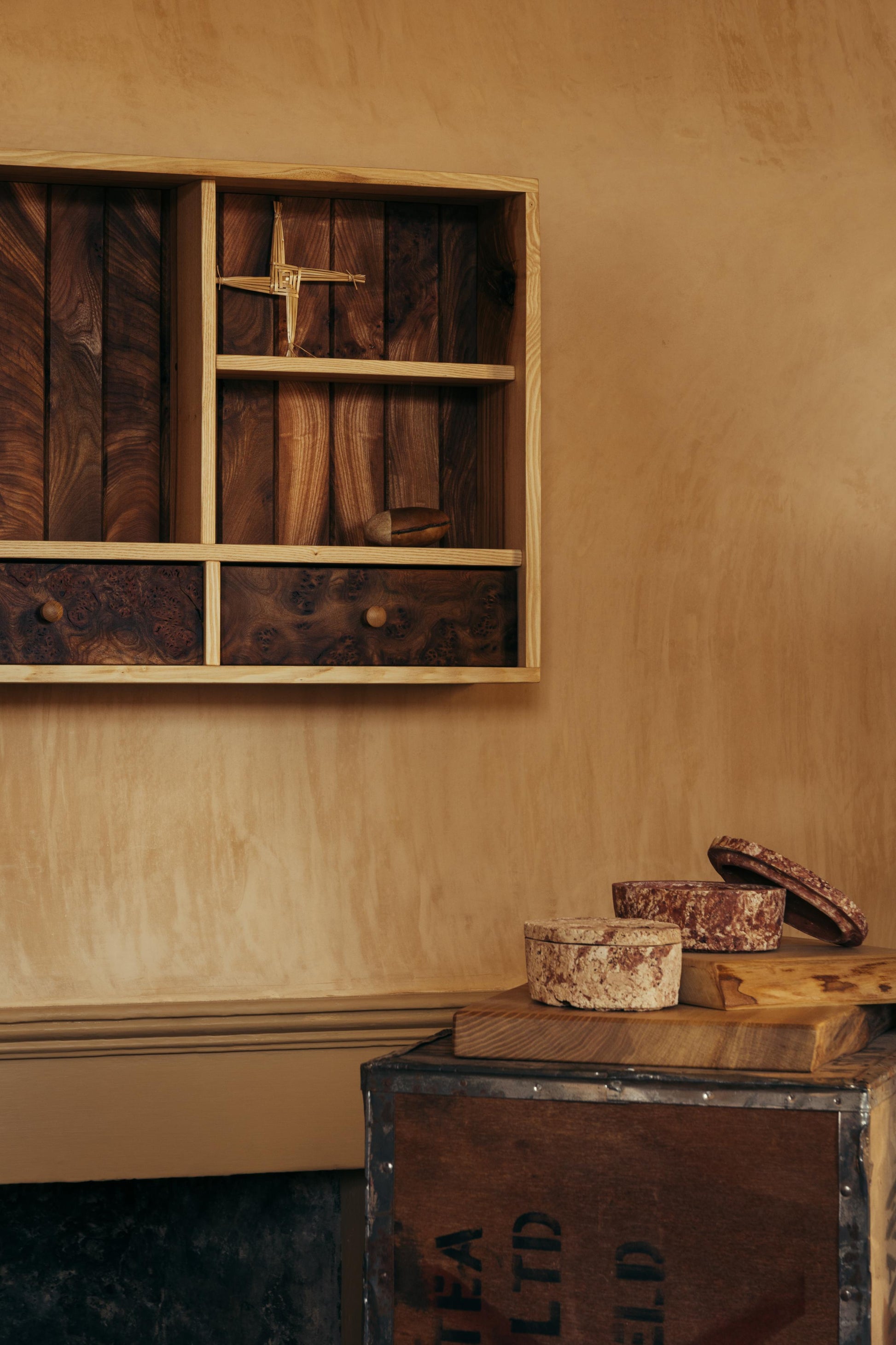 ALT= On the wall at Bard Scotland sits Tom Addy's storage shelf Prìseil. The shelf has two drawers and is made of Stirlingshire Ash and Deeside Elm.