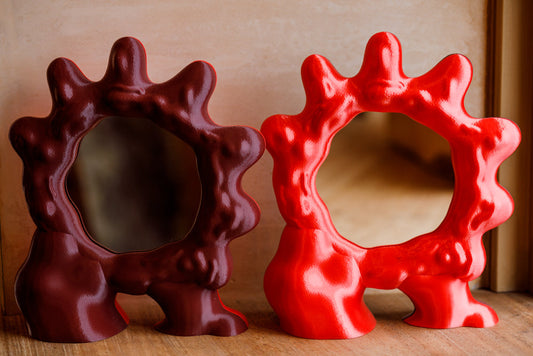 ALT=Sun mirror by Wobbly Digital Studio. 3D printed mirrors made in Glasgow. Bright satin red on one side, and a deep red on the other.