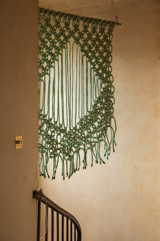 ALT=Large aqua wall hanging by A Frayed Knot. Made from sea rope found washed up on the beaches of Orkney. Hung in the hallway of Bard, a shop and gallery in Leith, Scotland. 