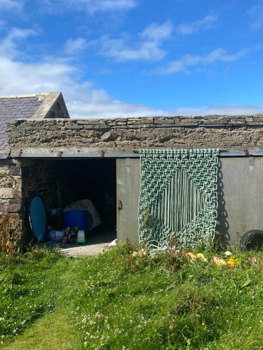 ALT=Sea rope hanging by A Frayed Knot. Hung at its birthplace in Orkney.