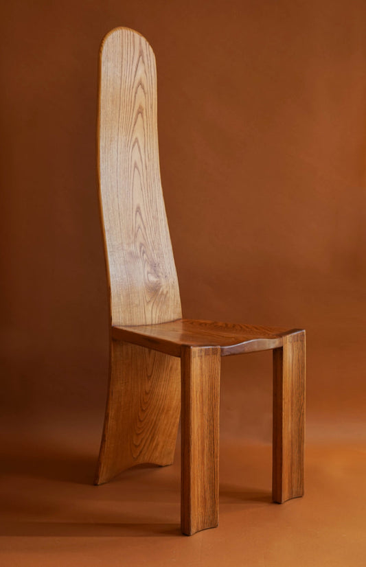 ALT=A 1970's high backed chair. Made in elm with with carved seats and curved, laminated backs.