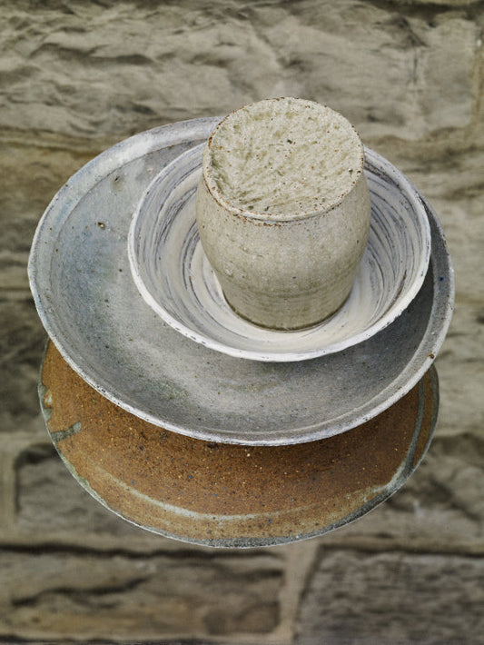 ALT=A textured, hand-thrown ceramic jar by Ingot Objects. Photographed within two other Ingot Objects ceramic pieces; the wild clay bowl and wild clay dish.