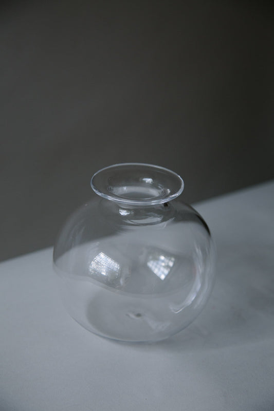 ALT=Globe shaped hand blown glass vase. Shot in monochrome and a singular vase shown. 
